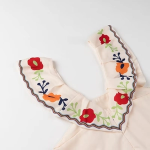 Detail of V-neck ruffled collar with colorful floral prints and wave-edge stitching