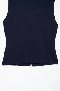 Detail of navy blue ribbed knit tank top showing high-quality hem and side slit design