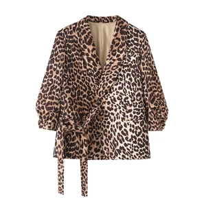 Detail of leopard print blazer showing peaked lapel, belted waist and puff sleeves
