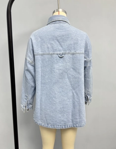 Back view of light blue washed denim jacket with drop shoulders and center hanging loop
