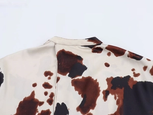 Detail shot of the stand-up collar and animal print fabric on a stylish women's set
