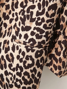Detail of leopard print blazer showing woven texture and welt pocket craftsmanship