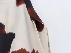 Macro view of animal print fabric texture and stitching details for the two-piece set