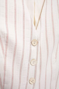 Close-up of striped linen vest with natural wooden buttons and premium woven texture
