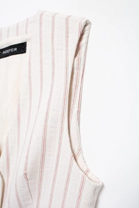 Detailed close-up of ivory woven fabric featuring elegant red vertical stripes and stitching