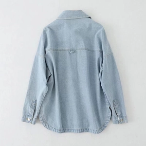 Back view of light blue washed denim jacket with curved hem and shoulder yoke detail
