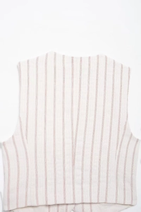 Close-up of the red vertical stripes and natural cotton linen texture on the vest back