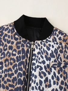 Detailed view of leopard print jacket with metal zipper and black ribbed collar