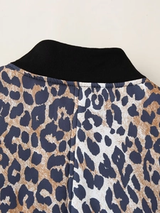 Detailed close-up of leopard print jacket with black ribbed collar and precise stitching