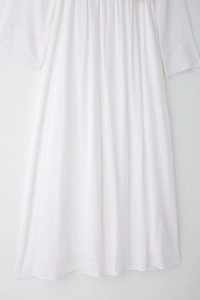 Detailed close-up showing the natural cotton linen texture of this white midi shirt dress
