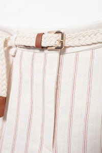 Close-up of beige striped fabric texture with woven belt and gold metal buckle detail