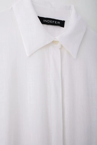 Detailed macro texture of breathable white linen cotton fabric on a shirt collar