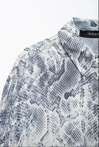 Detail shot of snake skin print shirt collar with buttons and fabric texture