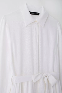Detailed view of white cotton linen shirt dress with waist tie and hidden placket