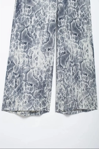 Detailed view of lightweight python print fabric on these wide leg trousers for women