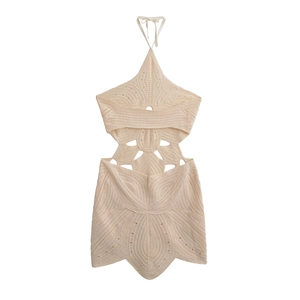 Chic beige crochet halter dress with geometric cut-outs and a bohemian holiday style
