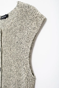 Close-up of mixed cotton knit fabric texture and brand label on a sleeveless top