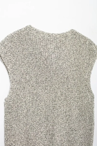Detailed close-up of marled cotton knit fabric texture on a beige sleeveless vest top