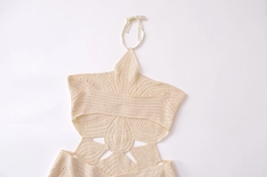 Close-up of cream crochet halter top featuring intricate star-shaped openwork patterns