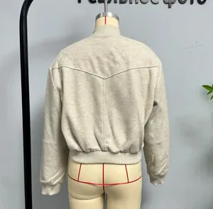 Detail view of light grey wool-like bomber jacket with V-shaped back stitching and ribbed hem
