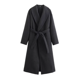 Detail of elegant black wool coat featuring a shawl collar and waist belt tie closure