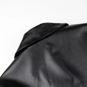 Detailed view of the stitching and texture on the back of this long black leather jacket