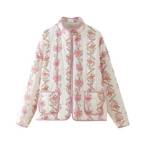 Detail of floral printed quilted jacket with mandarin collar and pink piped edge trim