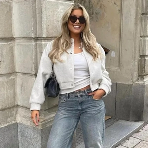 Women's light grey oversized bomber jacket with ribbed cuffs and snap button closure