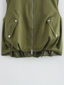 Detail of army green utility vest featuring metal zipper and snap button pockets