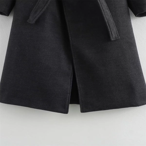 Close-up of thick dark grey wool coat fabric with belt detail and high-quality stitching