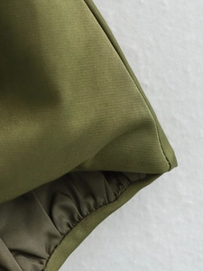 Detailed macro view of military green fabric stitching and elastic cuff hem construction