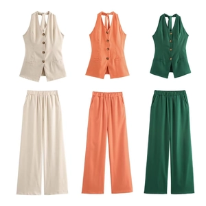 Close-up of cotton linen halter vest and wide-leg pants set in cream, orange, and green