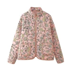 Detail view of the floral quilted jacket showing the vintage print and zipper texture