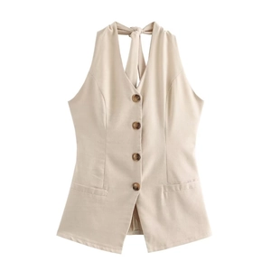 Detailed view of beige halter vest featuring deep amber buttons and waist pocket details
