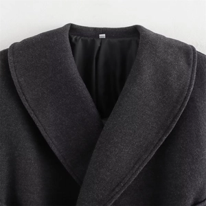 Close-up of a charcoal grey wool coat collar with wide lapels and black silky lining