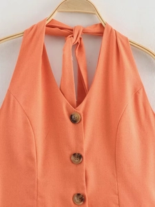 Detail of orange linen halter top with V-neckline and decorative resin buttons
