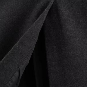Detailed close-up of heavy dark grey wool fabric with smooth black inner lining