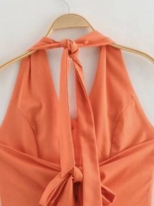 Detail of orange halter neck top with textured cotton linen fabric and tie-front bow