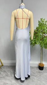 Detail showing the elegant backless design and thin crisscross straps of the satin maxi dress