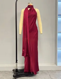 Detail of burgundy satin dress showing the neck halter ties and elegant draped fabric texture
