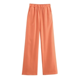 Detail of coral high-waisted wide-leg trousers with elasticated waist and side pockets