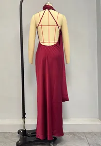 Detail of burgundy backless satin maxi dress featuring crisscross straps and draped fabric