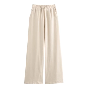 Detail of high waist elastic waistband and side pockets on beige wide-leg cotton pants