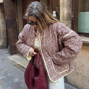 Quilted cotton jacket with vintage floral print and woven burgundy leather handbag in street view