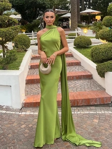 Detail of lime green satin maxi dress showing the halter neck and long flowing sash