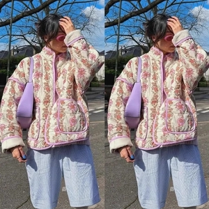 Chic quilted floral jacket with purple piping and large pockets in a street fashion look
