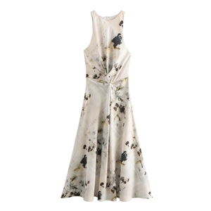 Close-up of abstract ink print dress featuring a twisted waist detail and satin texture