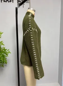 Detail of army green chunky knit sweater featuring white contrast stitching on the shoulder