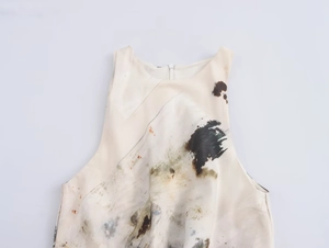 Detail of artistic ink print on sleeveless pleated dress with hidden back zipper