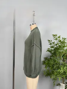 Detail view of sage green mock neck knit sweater with ribbed cuffs and drop shoulder